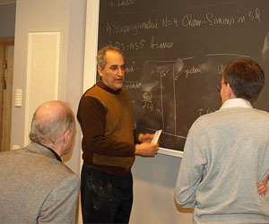 Scientists at blackboard