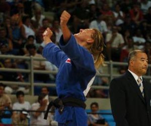 An Olympic judo athlete shows a dominance threat display following victory by SF State