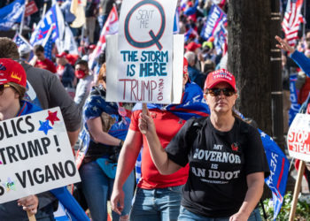 A group of Trump supporters in Washington, D.C., including one holding a QAnon sign. (Photo credit: Geoff Livingston)