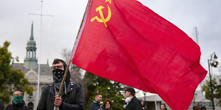 Left-wing protester holding a Soviet Union flag in Berkeley, California, in 2017. (Photo credit: David Gould)